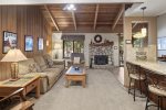  Open Area Living Room has a Woodstove and Vaulted Ceilings